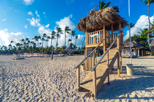 Lifeguard house with blue sky and vacation houses behind.