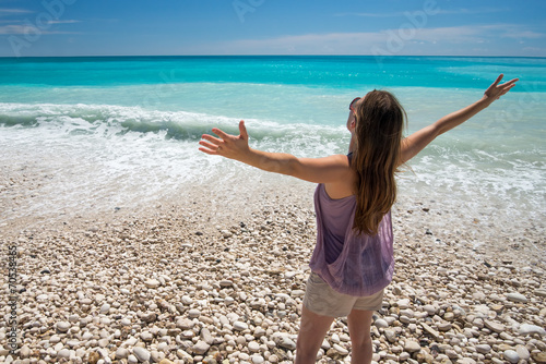Freedom and carefree woman on beach. Tropical ocean nature.
