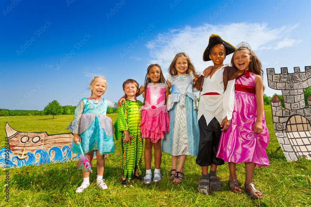 Obraz premium Kids diversity in costumes stand close and hug