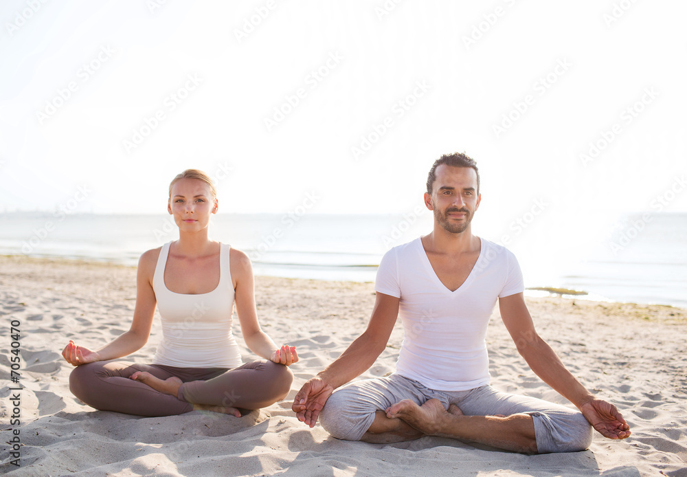 smiling couple making yoga exercises outdoors smiling couple making yoga exercises outdoors