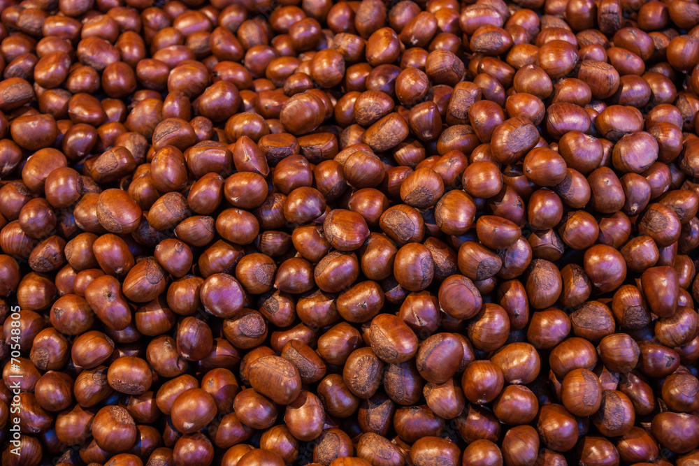 Pile of roasted chestnut for retail sale in market. Pile of roasted chestnut for retail sale in market.