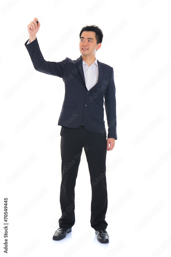 Asian male in coat writing something on glass board with marker Asian male in coat writing something on glass board with marker