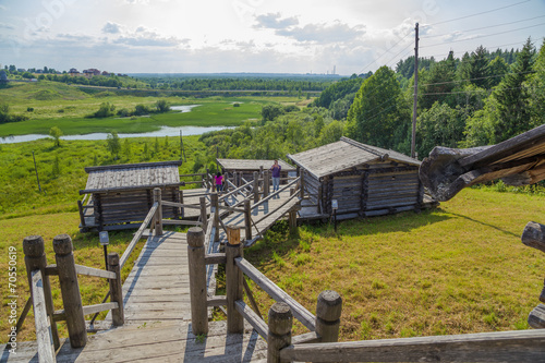 Малые Корелы, Россия. Пейзаж с банями на крутом берегу реки  photo