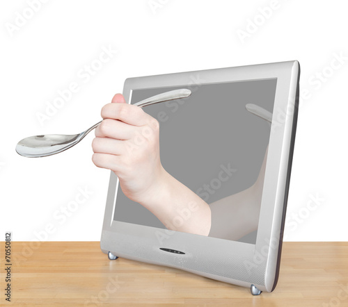 hand with soup spoon leans out TV screen photo