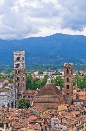 Cityscape of Lucca with cathedral and nearby mountains, Tuscany