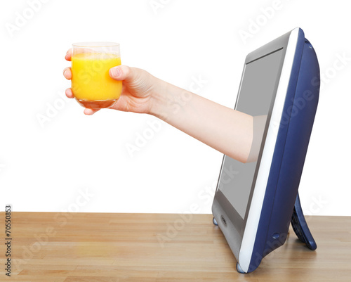 hand holding glass with orange juice leans out TV photo