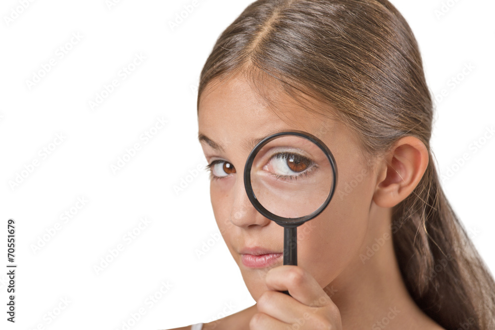 Child looking through a magnifying glass curious face expression Child looking through a magnifying glass curious face expression
