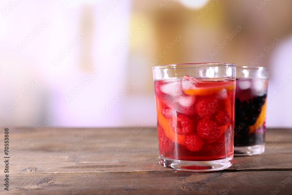 Glasses of cold berry cocktail on wooden table Glasses of cold berry cocktail on wooden table
