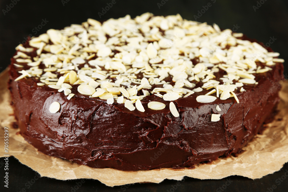 Tasty chocolate cake with almond, on wooden table