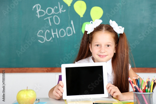 Cute girl with tablet at wo...