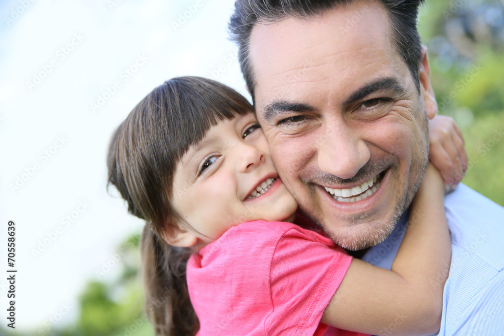 Portrait of little girl hugging her daddy Portrait of little girl hugging her daddy
