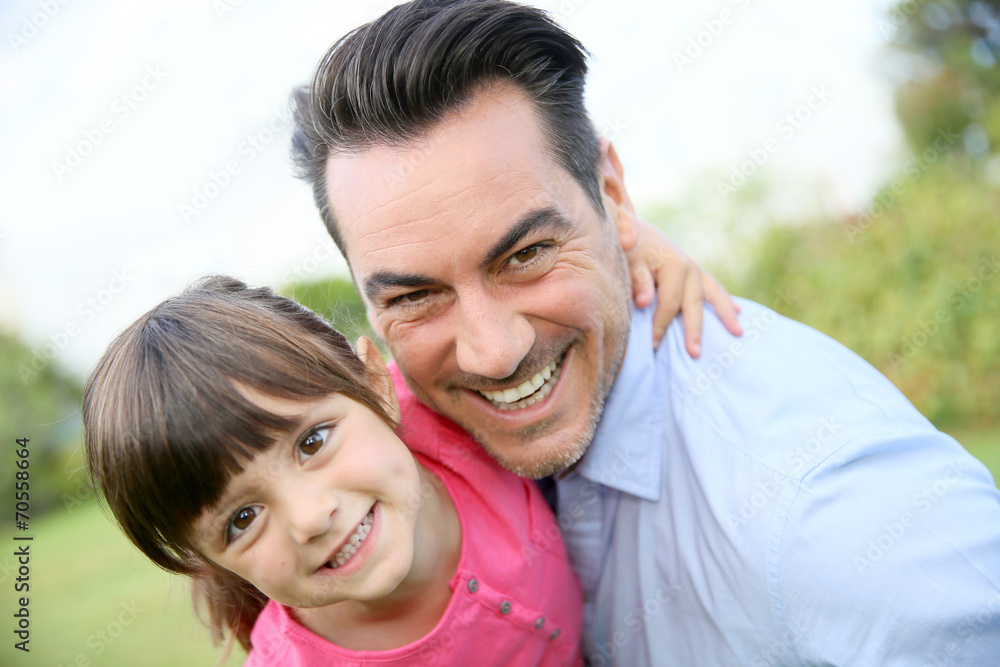 Portrait of little girl hugging her daddy Portrait of little girl hugging her daddy