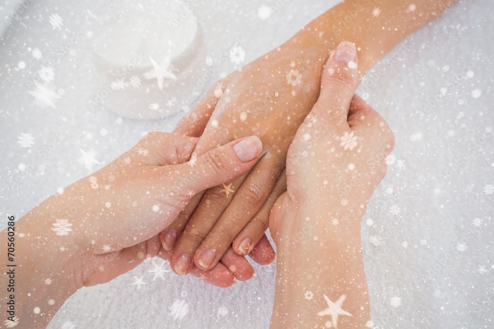 Composite image of hands applying cream Composite image of hands applying cream