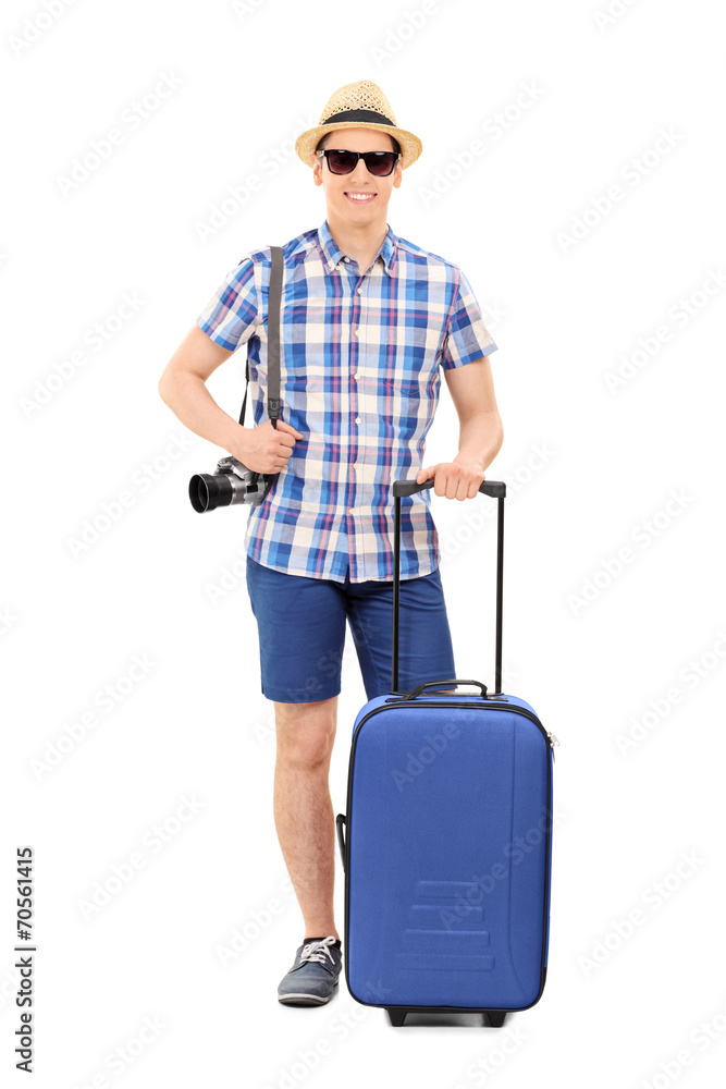 Young male tourist posing with his baggage Young male tourist posing with his baggage