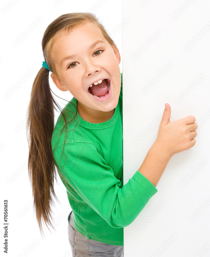 Little girl is looking from out blank board Little girl is looking from out blank board
