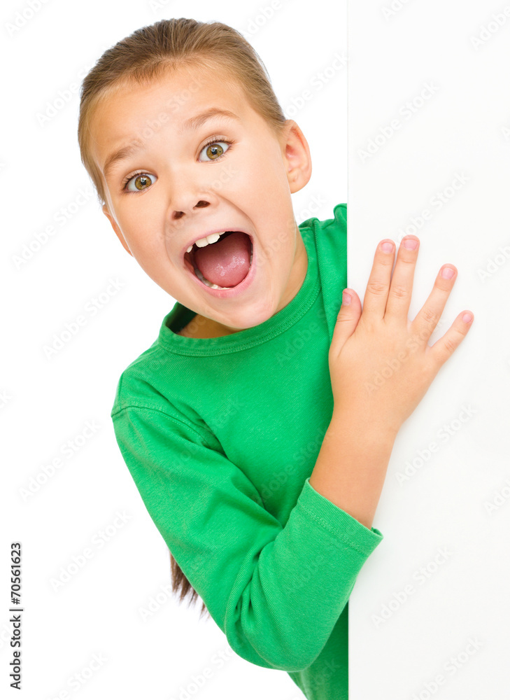 Little girl is looking out from the blank banner