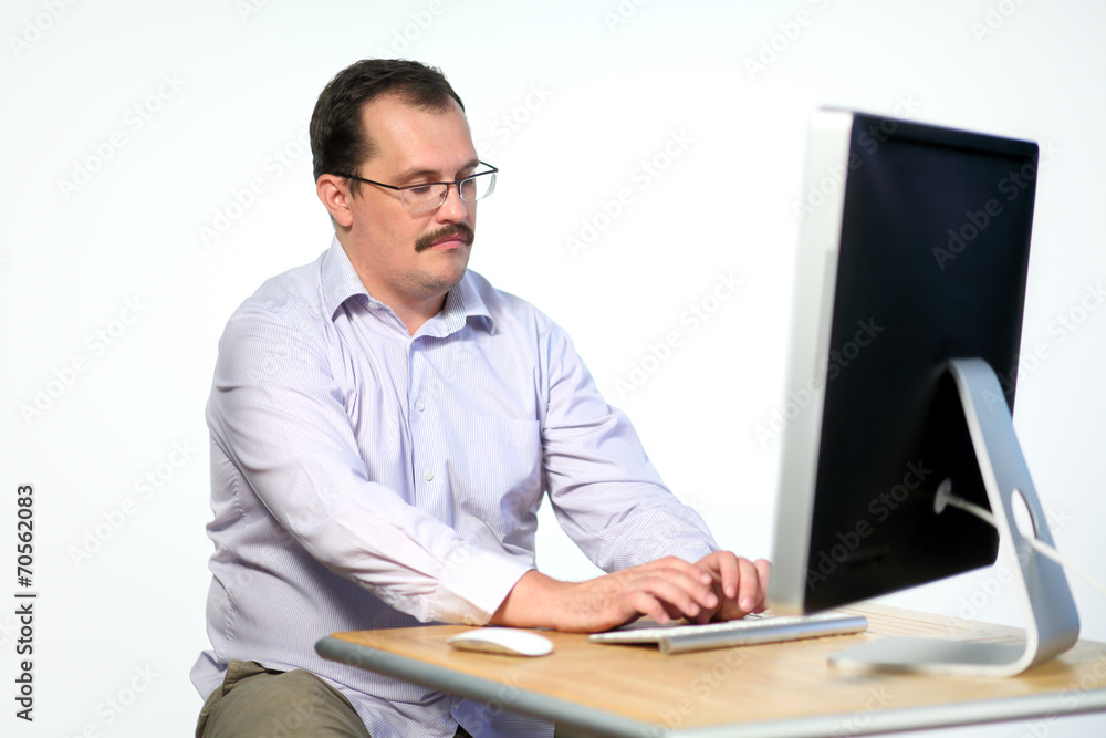 Tired employee in glasses asleep while working on computer Tired employee in glasses asleep while working on computer