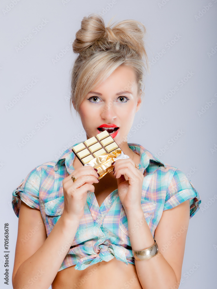 portrait of young woman sexy girl eating chocolate on blue portrait of young woman sexy girl eating chocolate on blue