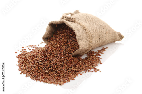 grade brown rice grain "devzira" razbrossany near the bag on a w