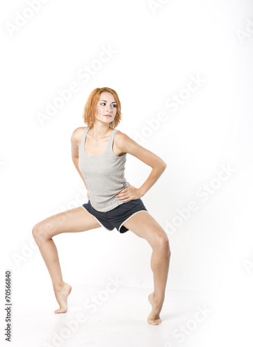 Young slim girl doing morning exercises