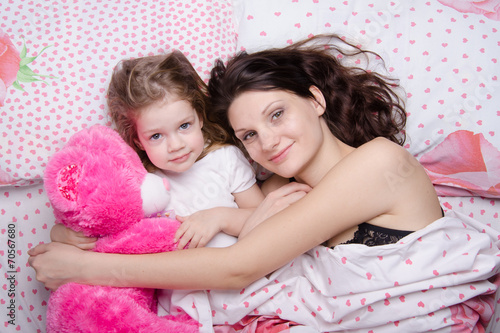 Mom and daughter lying in bed