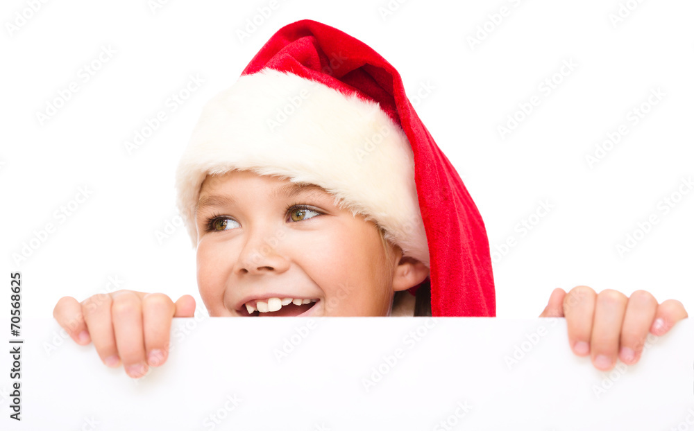 Little girl in santa hat is holding blank board Little girl in santa hat is holding blank board