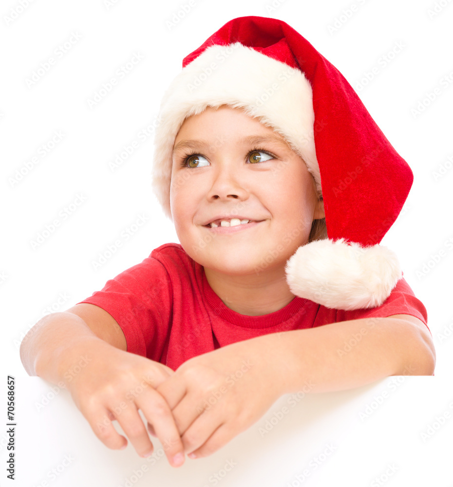 Little girl in santa hat is holding blank board Little girl in santa hat is holding blank board