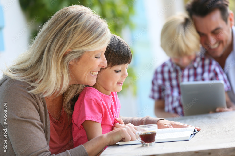 Woman with daughter teaching how to read Woman with daughter teaching how to read