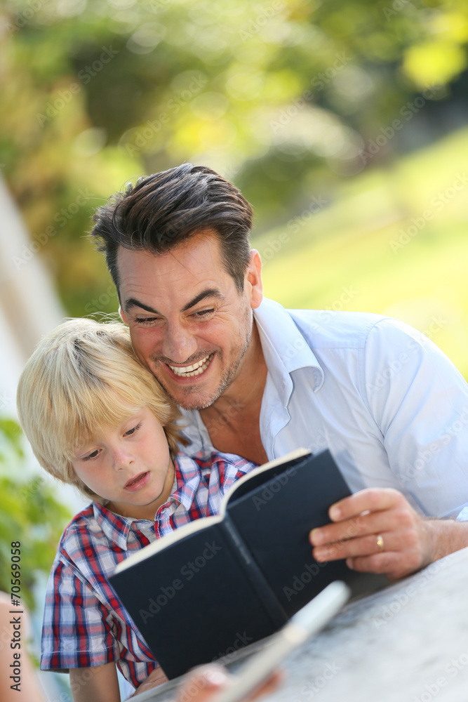 Daddy with kid reading book Daddy with kid reading book