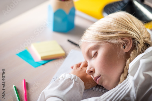 Sleeping school girl in classroom