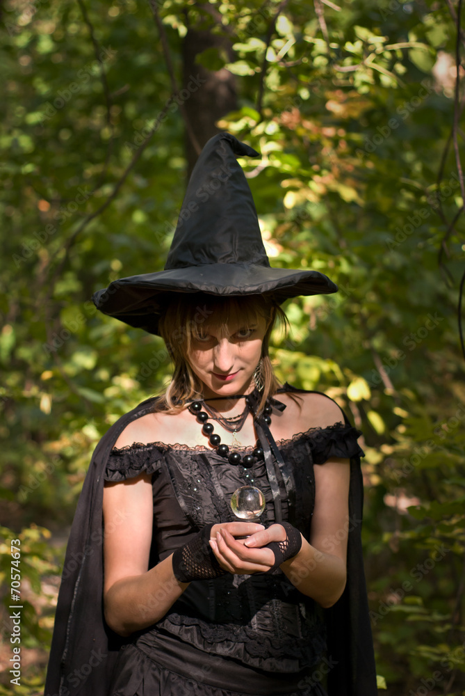Halloween Witch with Crystal Ball in the Forest