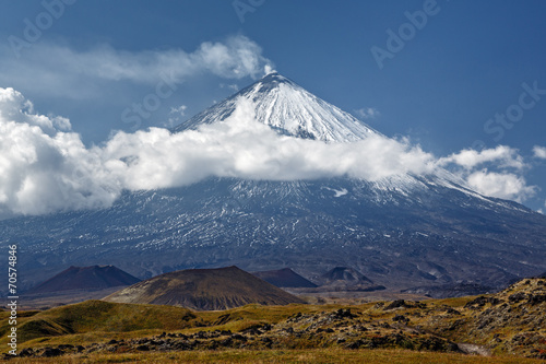 Scenery mountain landscape - eruption active Klyuchevskoy Volcano (Klyuchevskaya Sopka) is stratovolcano, highest mountain on Kamchatka Peninsula, highest active volcano of Eurasia.