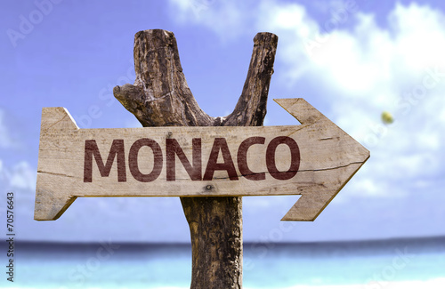 Monaco wooden sign with a beach on background