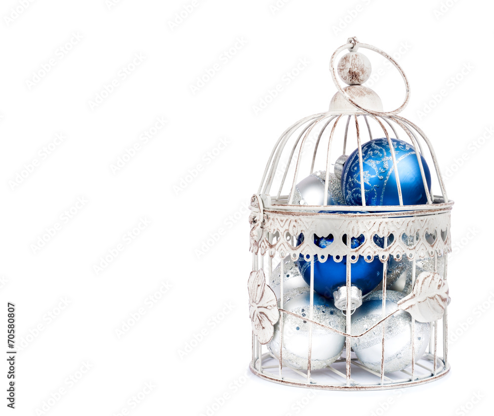 Blue and silver christmas balls in cage on the  isolated white b