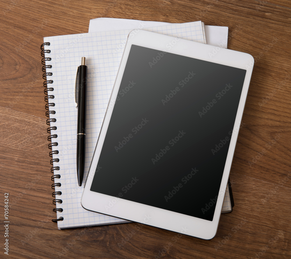 digital tablet on a wooden background digital tablet on a wooden background