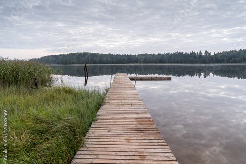 reflection of clouds in the lake with boardwalk