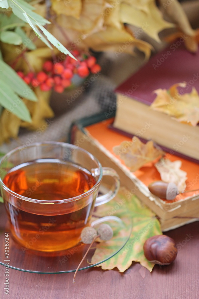 Still life with tea, books and autumn leaves Still life with tea, books and autumn leaves