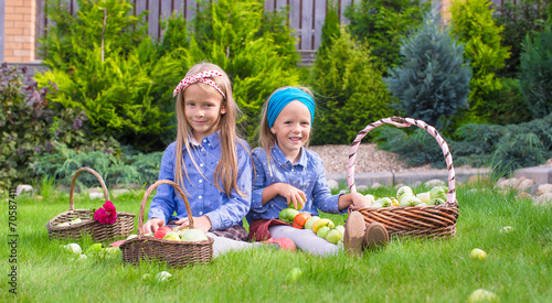 Two little happy girls with great autumn harvest of tomatoes in © travnikovstudio