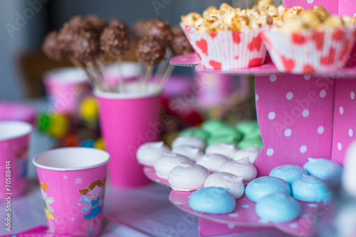 Sweet colored meringues, popcorn, custard cakes and cake pops on