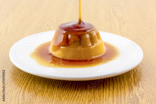 Creme caramel vanilla custard dessert or flan on white dish