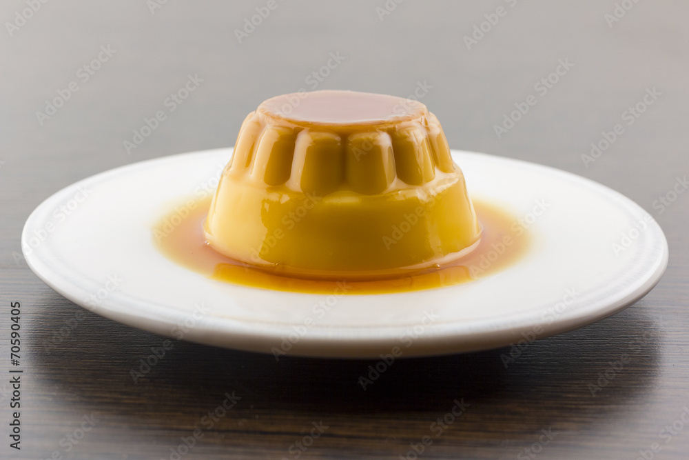 Creme caramel vanilla custard dessert or flan on white dish Creme caramel vanilla custard dessert or flan on white dish