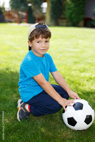Little boy in cap with soccer ball