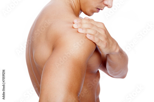 Muscular man with shoulder pain, isolated on white background photo