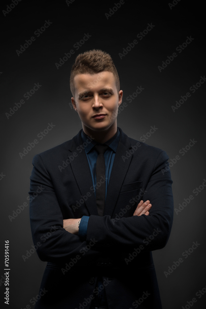 Waist-up portrait of handsome businessman with strong and confid