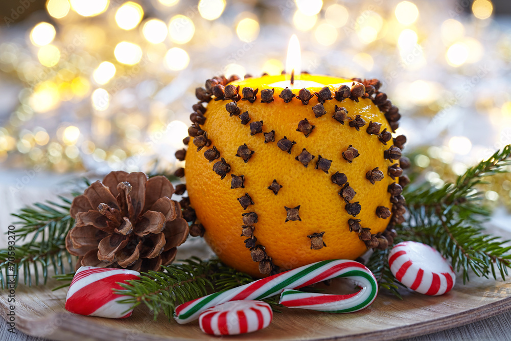 Aromatic Christmas orange with candle - obrazy, fototapety, plakaty 