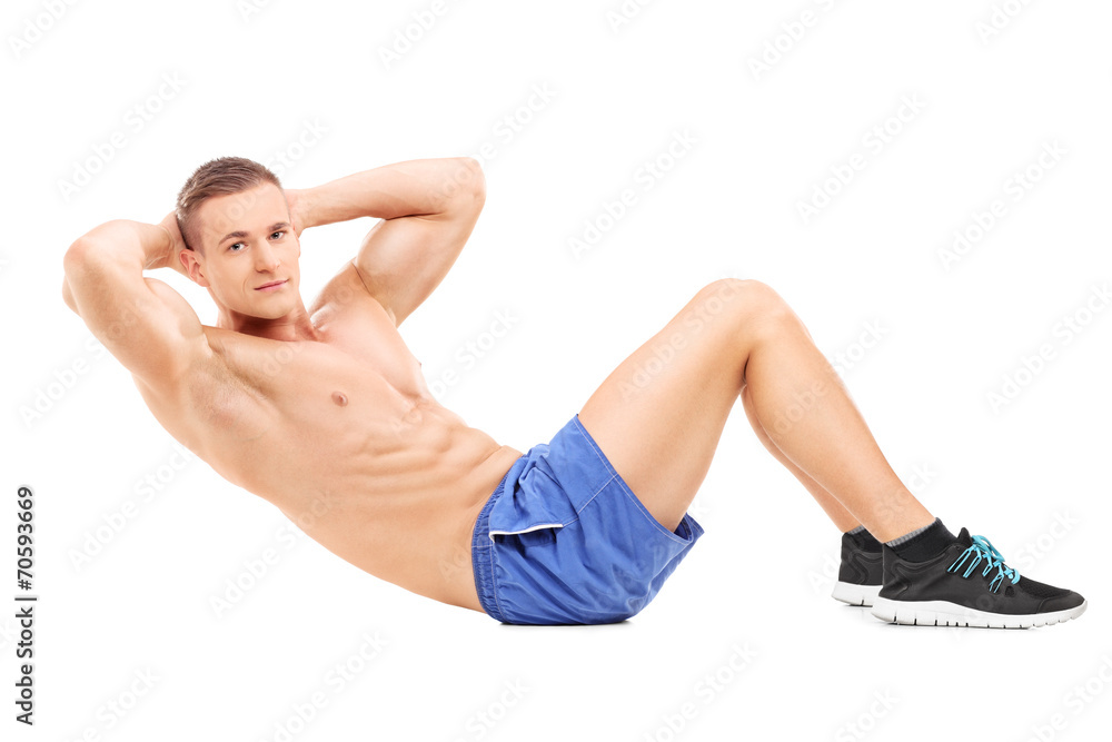 Handsome male athlete exercising on the floor Handsome male athlete exercising on the floor