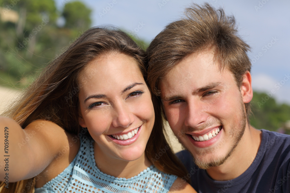 Couple photographing a selfie with the smart phone Couple photographing a selfie with the smart phone