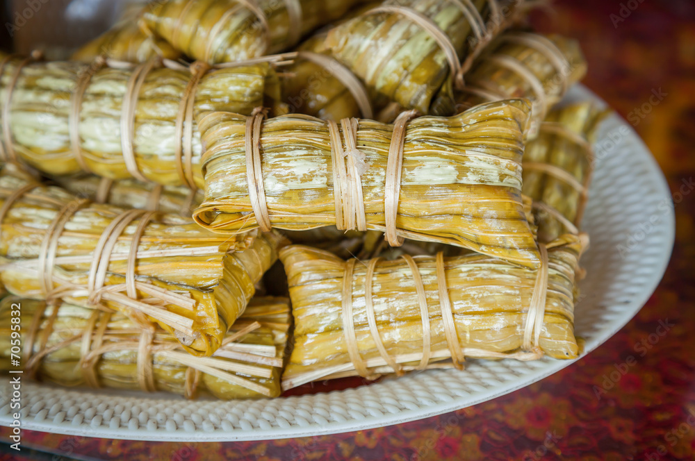 Thai traditional sticky rice dessert in banana leaf packaging. Thai traditional sticky rice dessert in banana leaf packaging.