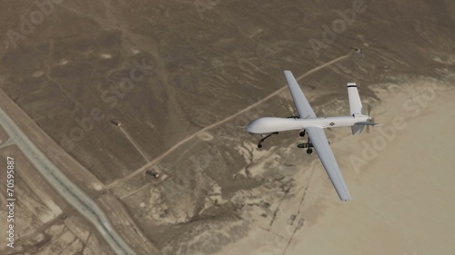 an armed drone in flight over desert - close up photo