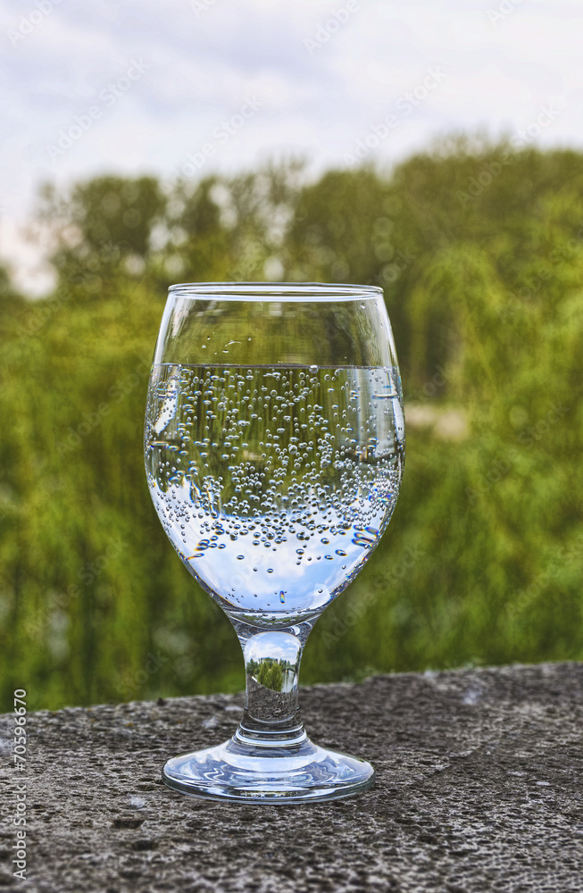 The shot glass with sparkling water The shot glass with sparkling water